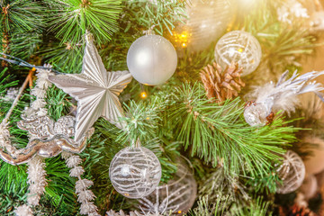 Classic Christmas decorated interior room with New year tree. Christmas tree with silver decorations and gift box. Modern white classical style interior design apartment. Christmas eve at home