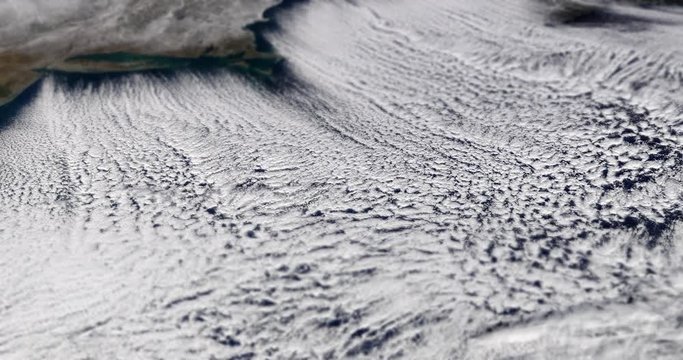 Very high-altitude circular tracking shot of clouds over the US east coast, with tilt-shift effect. Reversible, seamless loop. Elements of this image furnished by NASA. 