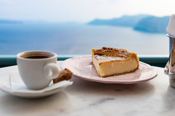 Coffee and cheese cake with sea view in Oia, Santorini Greece