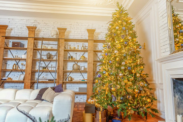 Classic christmas New Year decorated interior room New year tree. Christmas tree with gold decorations. Modern white classical style interior design apartment with fireplace. Christmas eve at home