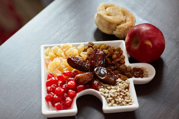 Dried fruits, an apple lying on a wooden table