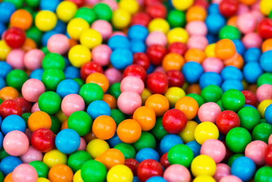 Rainbow colorful candy coated chocolate pieces in a bowl (selective focus)