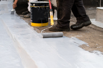Paint roller, insulating the roof of the building