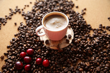 cup of coffee with beans on wooden background