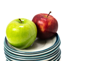 Green and Red Apple on a Stack of Plates