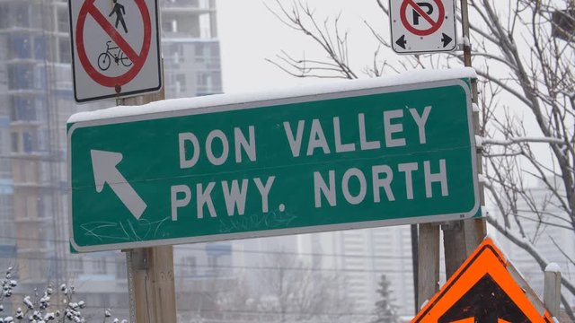 TORONTO, CANADA on Dec 12th: Sign for Don Valley Parkway North with snow falling in Toronto, Canada on Dec 12, 2017. The Don Valley Parkway or DVP connects the Gardiner Expressway with highway 401.