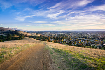 Hiking trail in the evening in Garin Dry Creek Pioneer Regional Park, Fremont and south San Francisco bay in the background, California