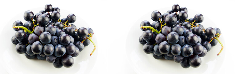  Tasty fresh black grape in a bowl and on white background