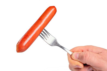 Sausage on fork in hand on white isolated background