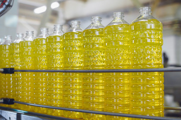 Line for the production of sunflower and olive oil. Bottles with oil close-up