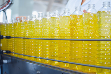 Line for the production of sunflower and olive oil. Bottles with oil close-up
