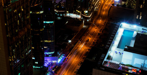 A luxury hotel pool in top view, city lights, Dubai, UAE. Night shot.