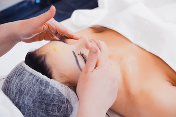Face massage.  Close-up of young woman getting spa massage treatment at beauty spa salon.Spa skin and body care. Facial beauty treatment.Cosmetology