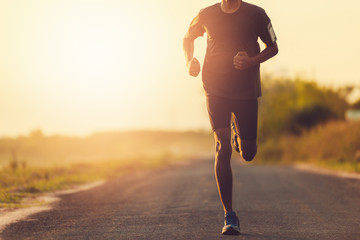 The man with runner on the street be running for exercise.