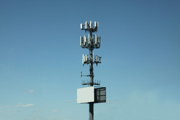 Communication pole line in blue sky and white sign