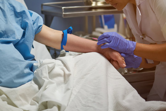 Nurse injecting in vein