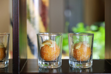 Potato Croquettes dessert in shot glasses on wood shelf