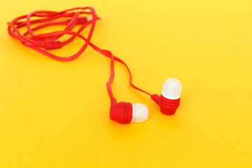 earbuds or earphones on yellow background