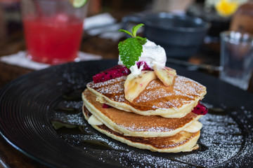 Pancakes with cream, banana and dragon fruit