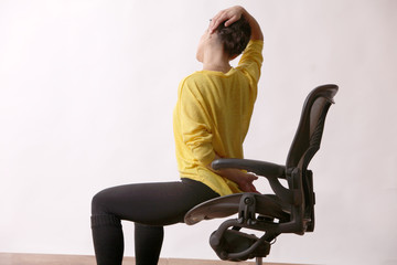Business woman practices exercises at workplace
