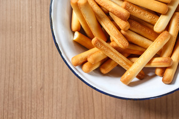 bread sticks top view on plate on table wooden.