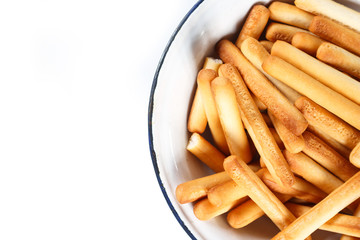 bread sticks top view on plate on white background.