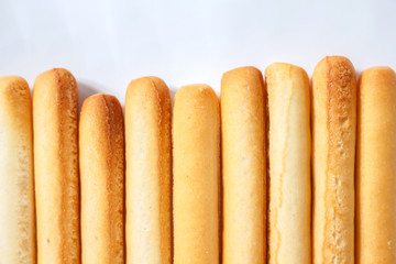 bread sticks top view on white background.