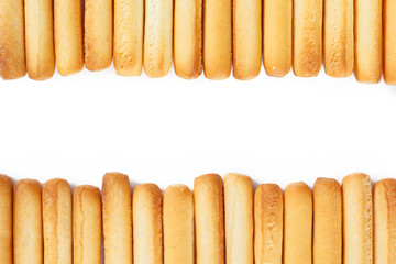 bread sticks top view border on white background.