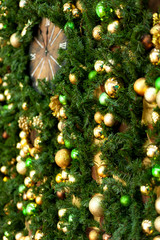 Christmas background. Wall decorated in green and gold colors with a clock
