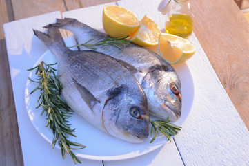 dorado fish on a black plate and wooden table