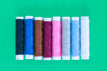 threads on green background.