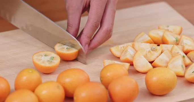 Cut of kumquat by knife