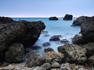 Quiet Ocean and rocks, flat water, averaged, time
