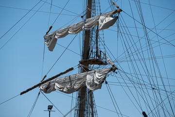 Masts of sailing ships against the blue sky.