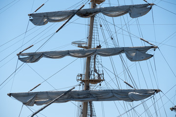 Masts of sailing ships against the blue sky.