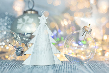 christmas glass balls with decorative fir tree on defocused background with lights garland