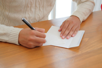 man writing christmas letter greeting card holiday wishes. xmas celebration.