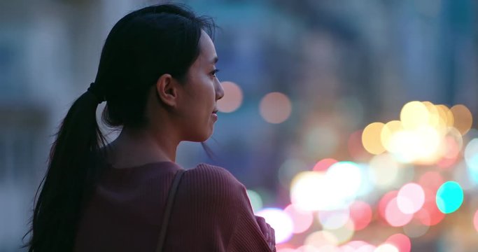 Woman look around in the city at night