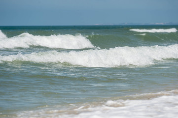 Fototapeta na wymiar Waves on the coast in windy weather close up