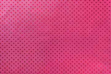 Dark purple background from metal foil paper with a stars pattern