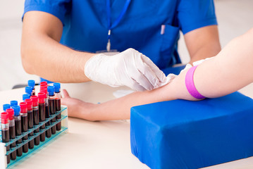 Young patient during blood test sampling procedure  