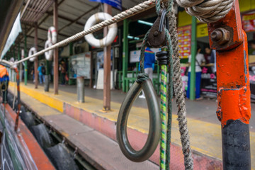 Fototapeta na wymiar Bokeh Shot from a Canal Boat with Focus on a Rope in Bangkok