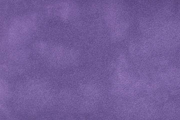 Dark violet matte background of suede fabric, closeup.