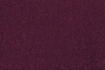 Dark purple matt suede fabric closeup. Velvet texture of felt.