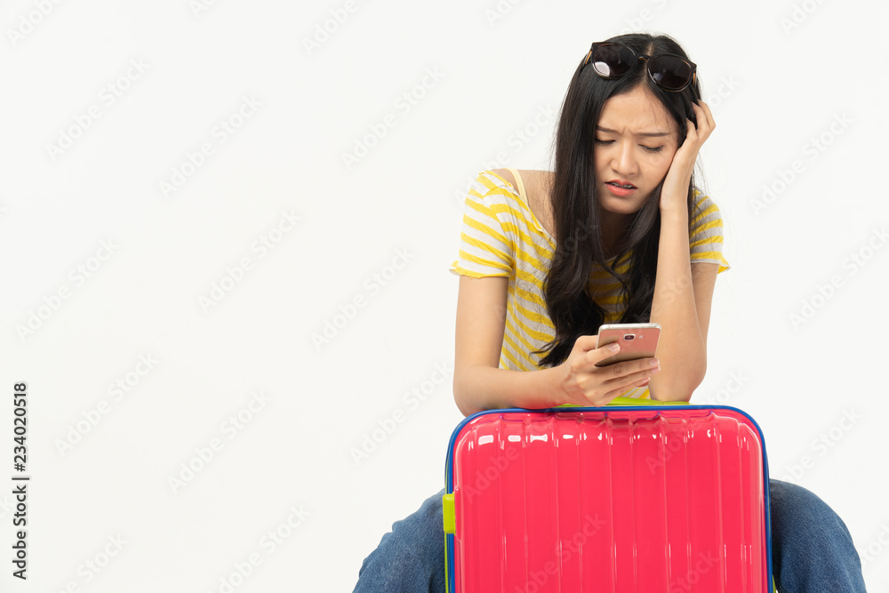 Wall mural beautiful young woman smiling and pulling pink color luggage isolated on white background.woman goin