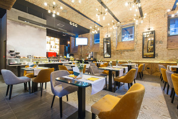 Interior of a modern hotel restaurant with brick wall - Powered by Adobe