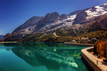 Lago Fedaia (Fedaia lake), an artificial lake and a dam near Canazei city, located at the foot of Marmolada massif, as seen from Viel del Pan refuge, Dolomites, Trentino, province of Belluno, Italy