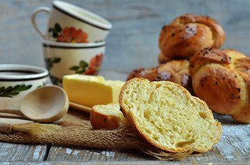 Obraz na płótnie Canvas Freshly baked Kaiser rolls with poppy seeds on a wooden background