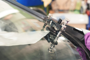 Close-up of polymer vacuum cracks installed on a cracked windshield for repairing cracks and chips