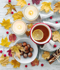 Fototapeta na wymiar autumn flat lay with cup of tea and leaves